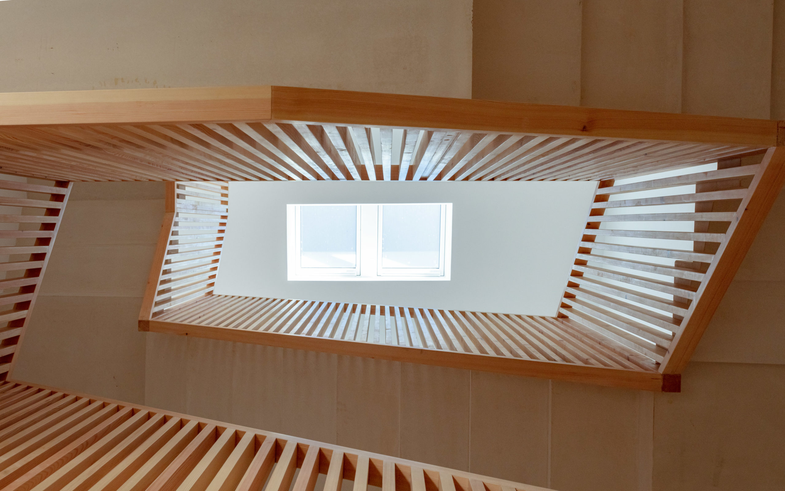 A new wooden stairway with a skylight was created leading up to the more private part of the house with the bedrooms.
