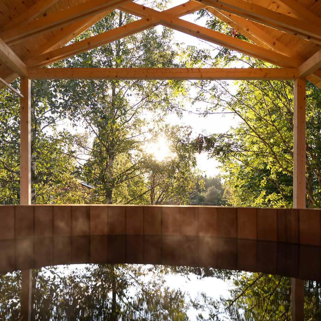 View of the Bathing Temple showing the water reflecting the trees and a bit of the roof structure