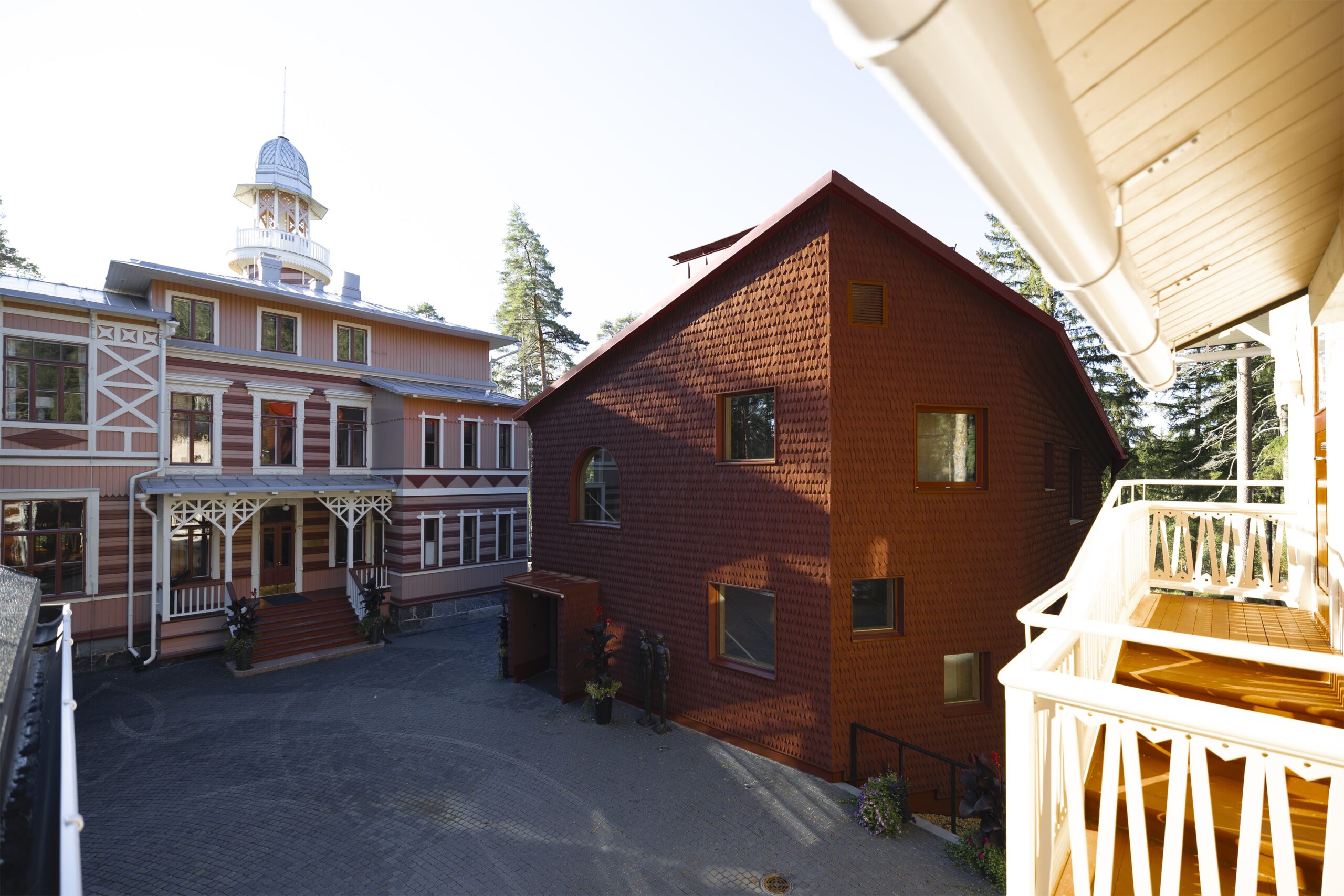 The new lodging house clad with red shingles complements the old castle building forming a sheltered yard