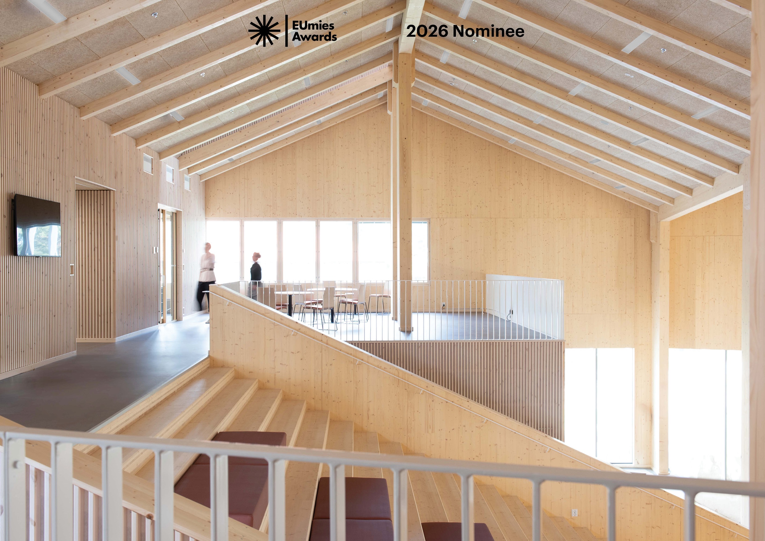 Photo showing the second floor lobby and the central stair of the wooden Lastu Education Building